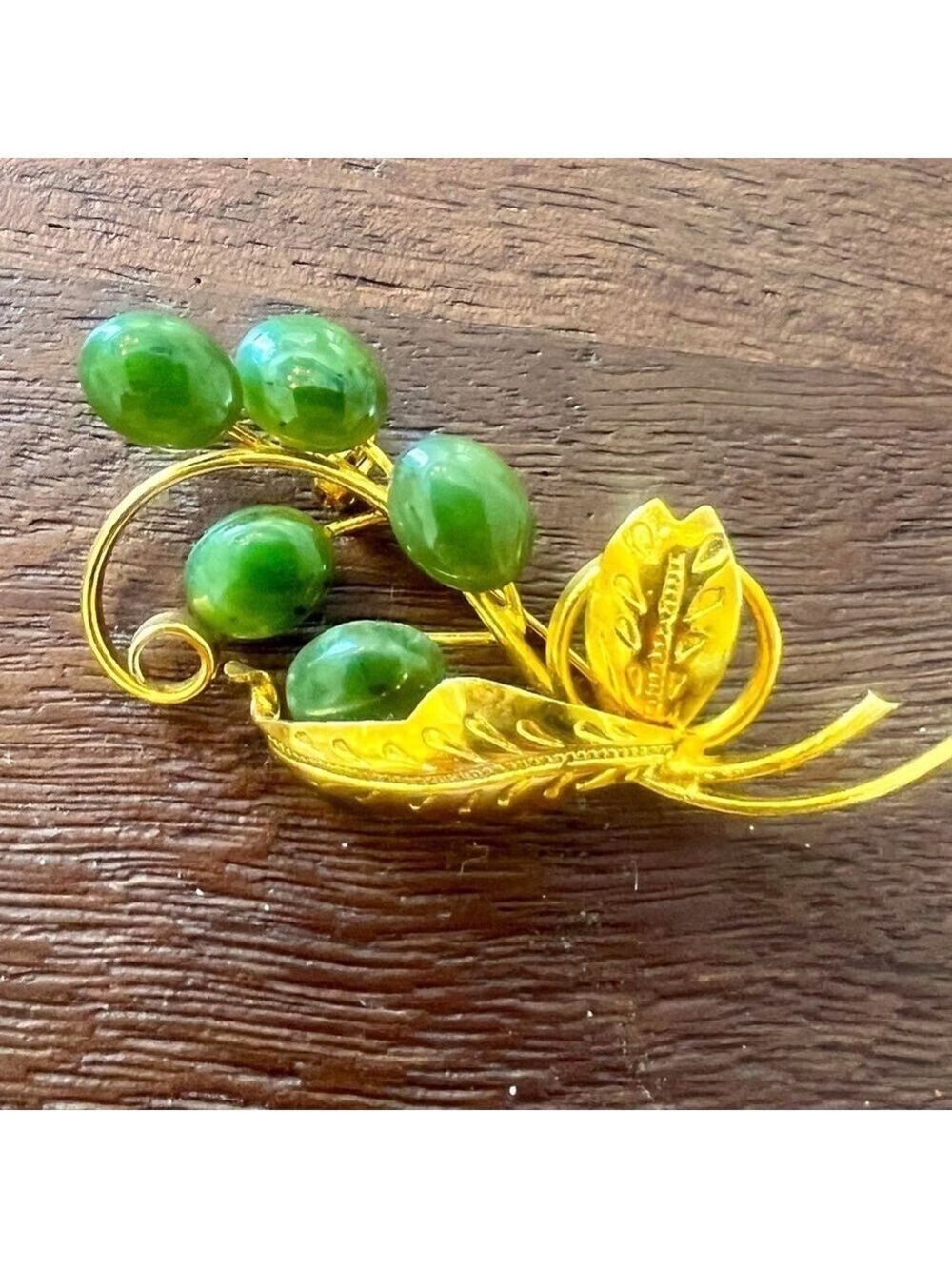 Vintage plated brooch with vines and engraved leaves.
